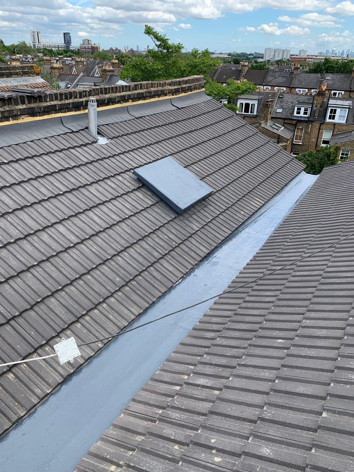 Refreshed pitched roof with new tiles and dressed lead in Richmond