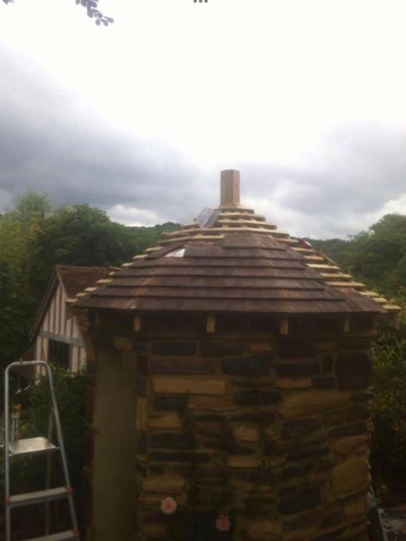 Stone garden turret being re-shingled with cedar shakes
