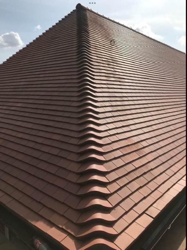 Newly tiled hipped roof completed by London Roofers in Whitton
